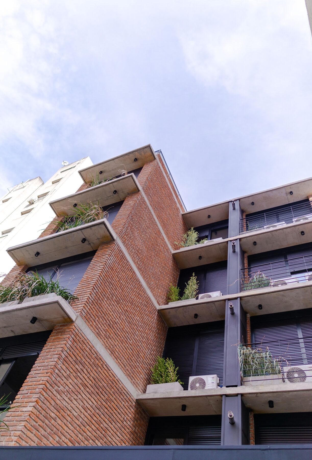 corner of the exposed brick building with its balconies