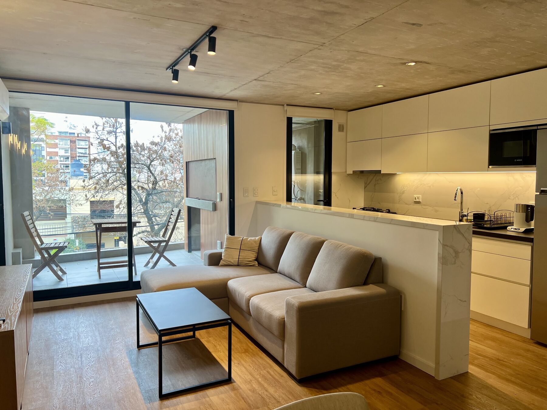 living and dining area open to the kitchen with access to the balcony