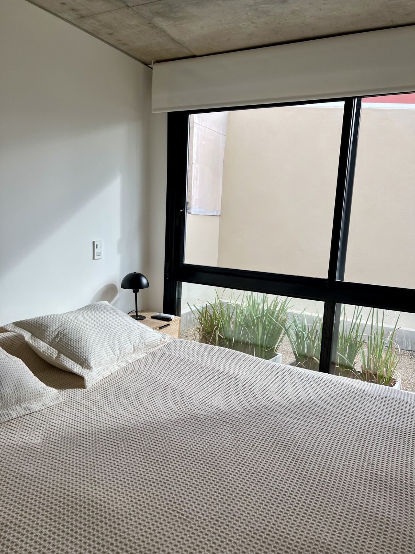 bedroom with a large window onto the garden