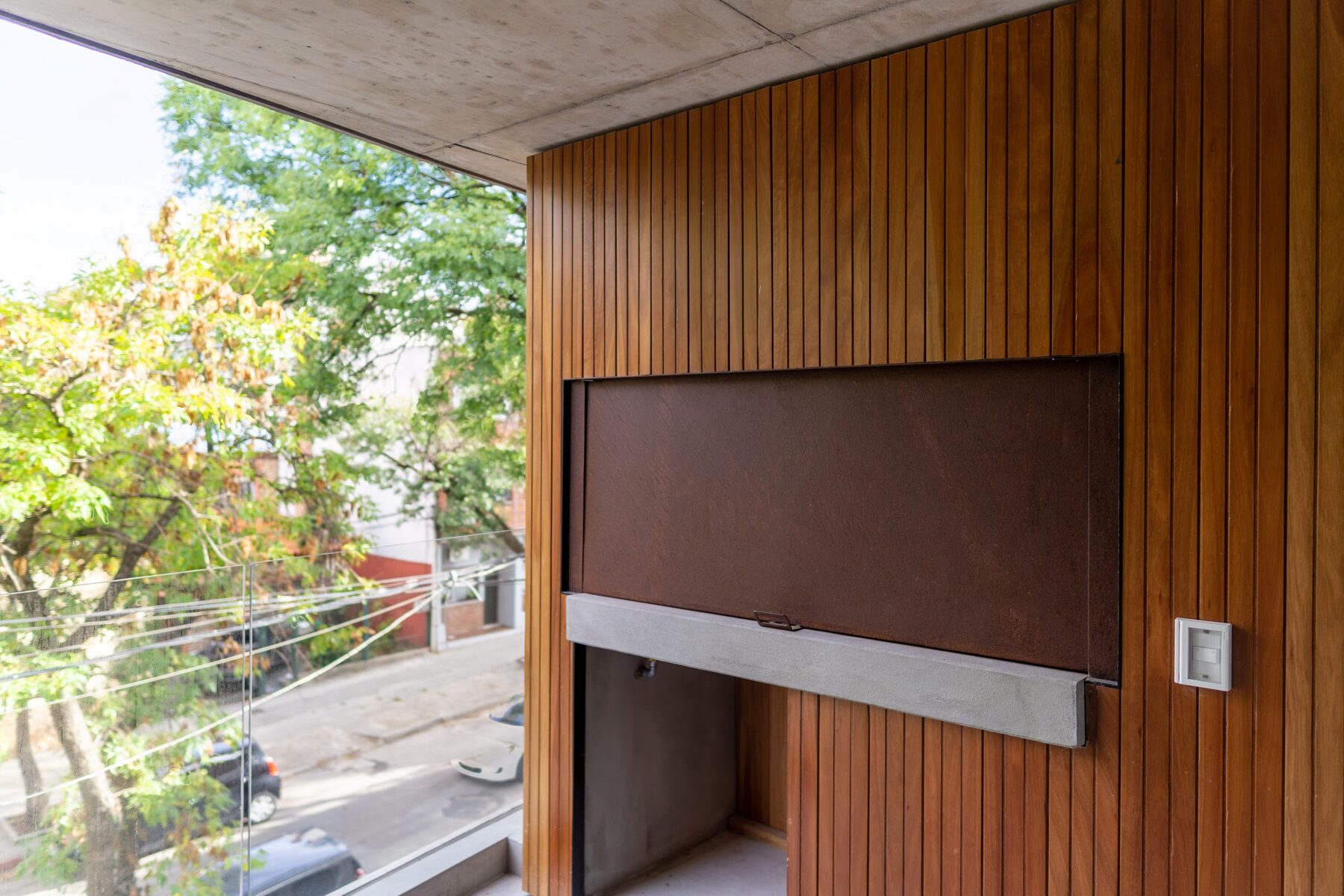 barbecue area clad in wood with a corten steel enclosure